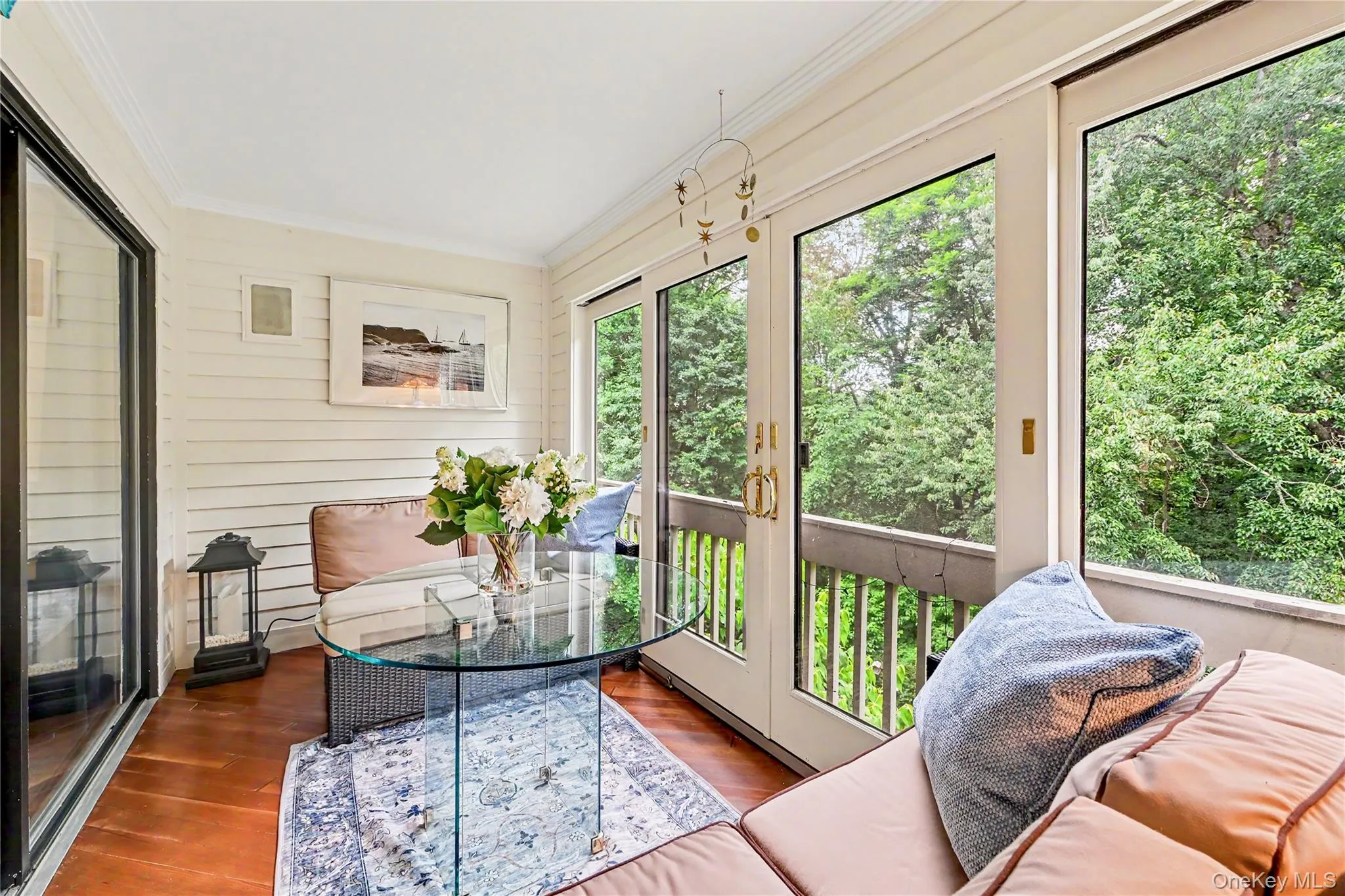 Three-season enclosed porch with wooded views. Three-season enclosed porch with wooded views.