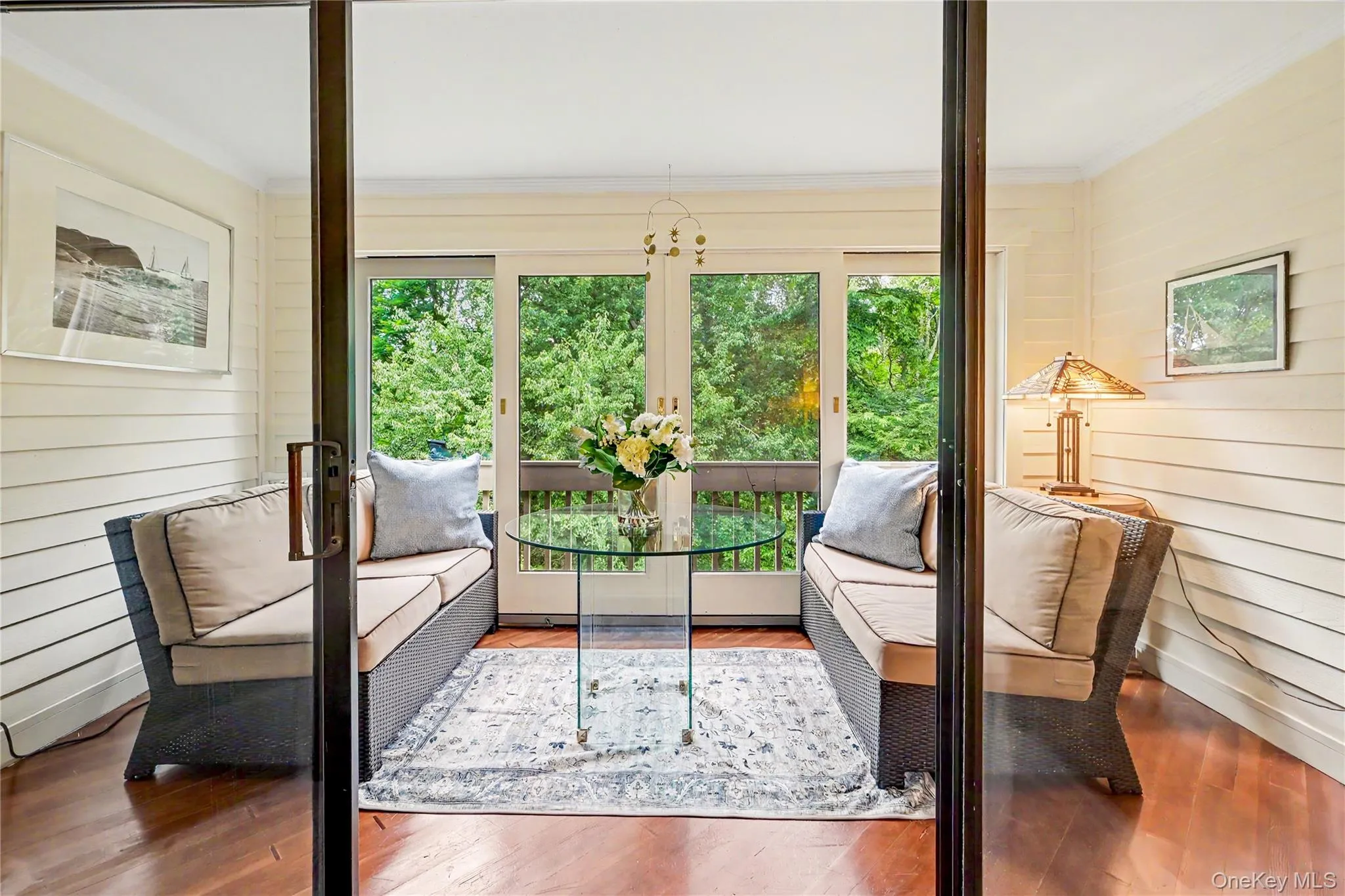 Three season enclosed porch with wooded views. Three season enclosed porch with wooded views.