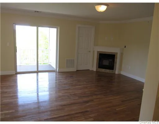 Relax or entertain in a spacious living room with a gas fireplace and sliding doors to a private deck leading to a grassy and treed area sliding doors to a patio overlooking a grassy area bordered by trees. Relax or entertain in a spacious living room with a gas fireplace and sliding doors to a private deck leading to a grassy and treed area sliding doors to a patio overlooking a grassy area bordered by trees.