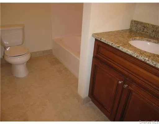 Pretty hallway bath has granite top vanity and a shower/tub combination Pretty hallway bath has granite top vanity and a shower/tub combination