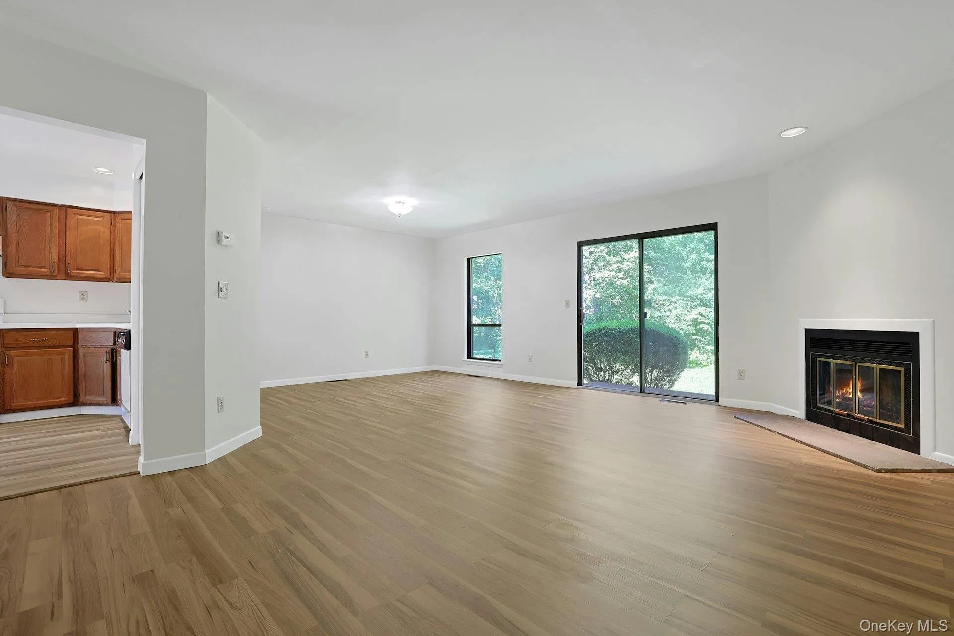 On the second level, the expansive living room is centered around a wood-burning fireplace with a wonderful granite hearth. On the second level, the expansive living room is centered around a wood-burning fireplace with a wonderful granite hearth.