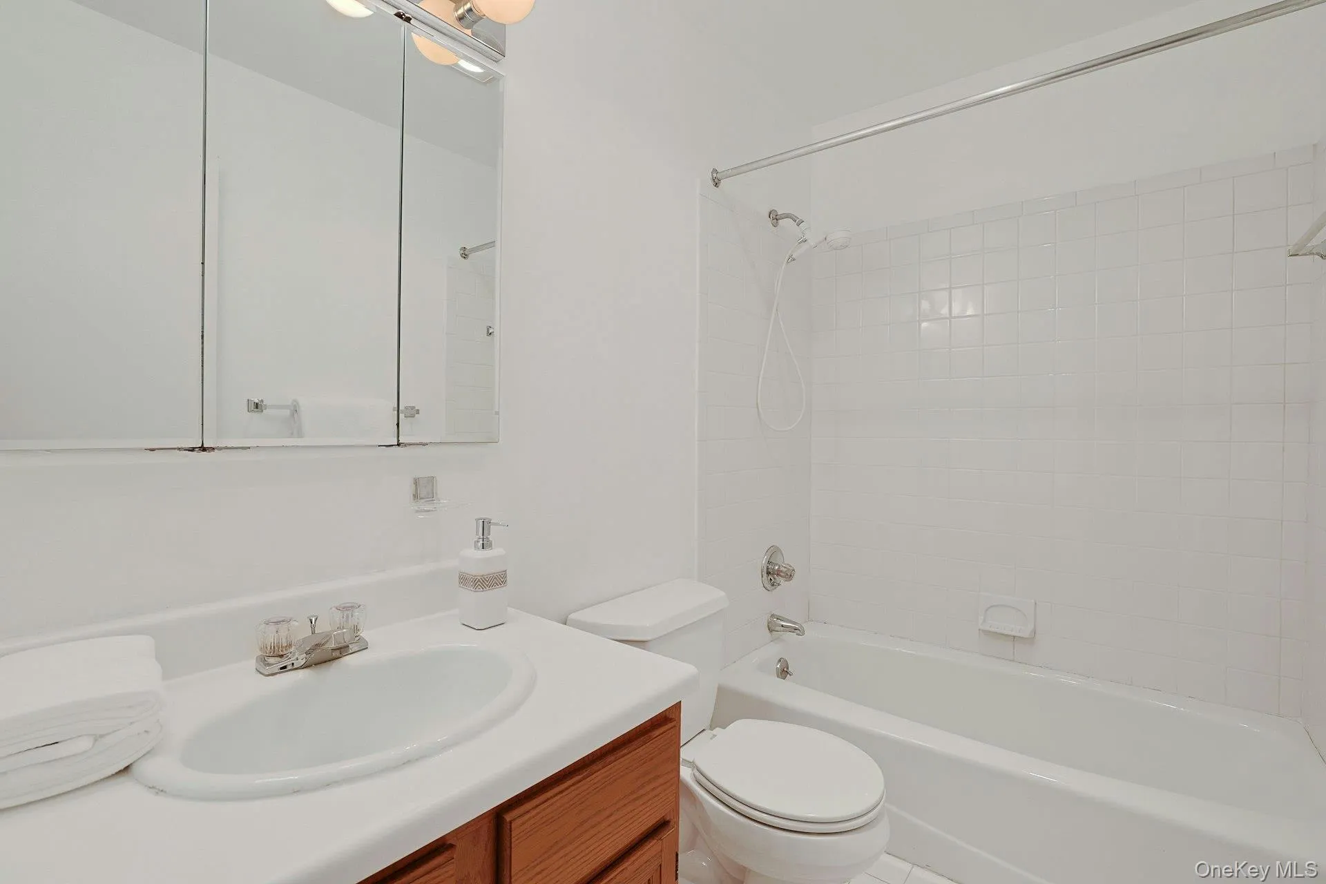 The full hall bathroom with a tub and shower is located close to the second and third bedrooms. The full hall bathroom with a tub and shower is located close to the second and third bedrooms.
