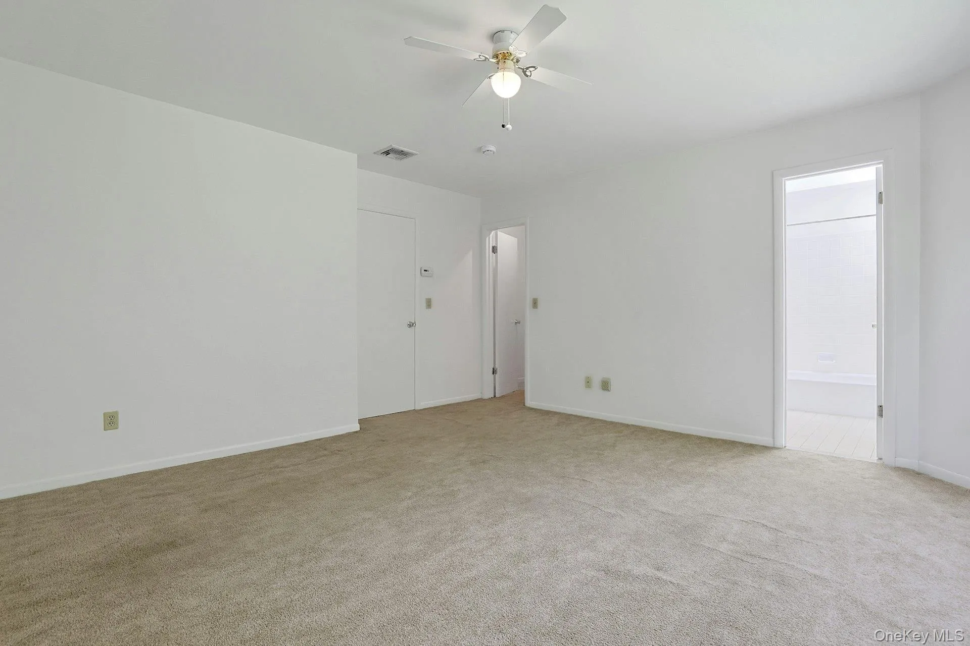 This view of the room shows the door to the deep walk-in closet. The ceiling fan is a great amenity for days when you don't want to turn the central air conditioning on. This view of the room shows the door to the deep walk-in closet. The ceiling fan is a great amenity for days when you don't want to turn the central air conditioning on.