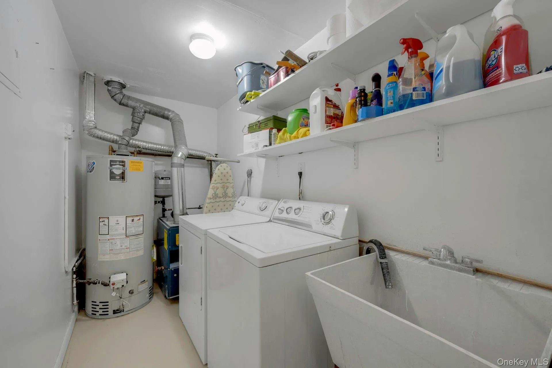 Laundry area with independent washer and dryer, laundry area, a sink, and gas water heater Laundry area with independent washer and dryer, laundry area, a sink, and gas water heater