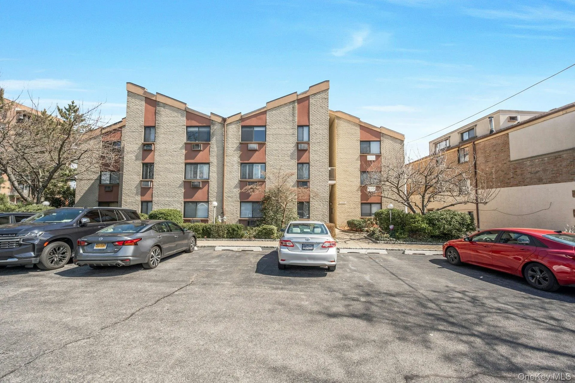View of building exterior with 1 assigned parking spot View of building exterior with 1 assigned parking spot