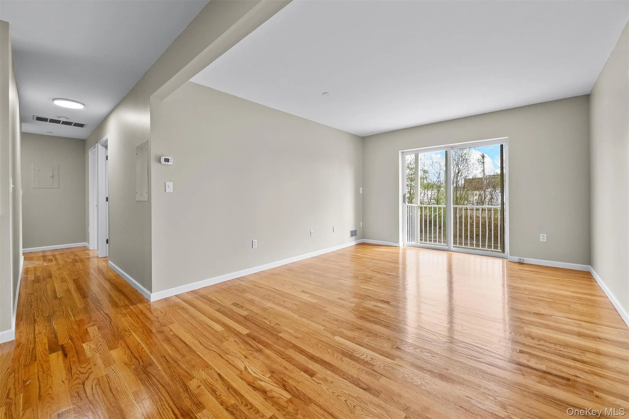 Unfurnished room featuring visible vents, light wood finished floors, and baseboards Unfurnished room featuring visible vents, light wood finished floors, and baseboards