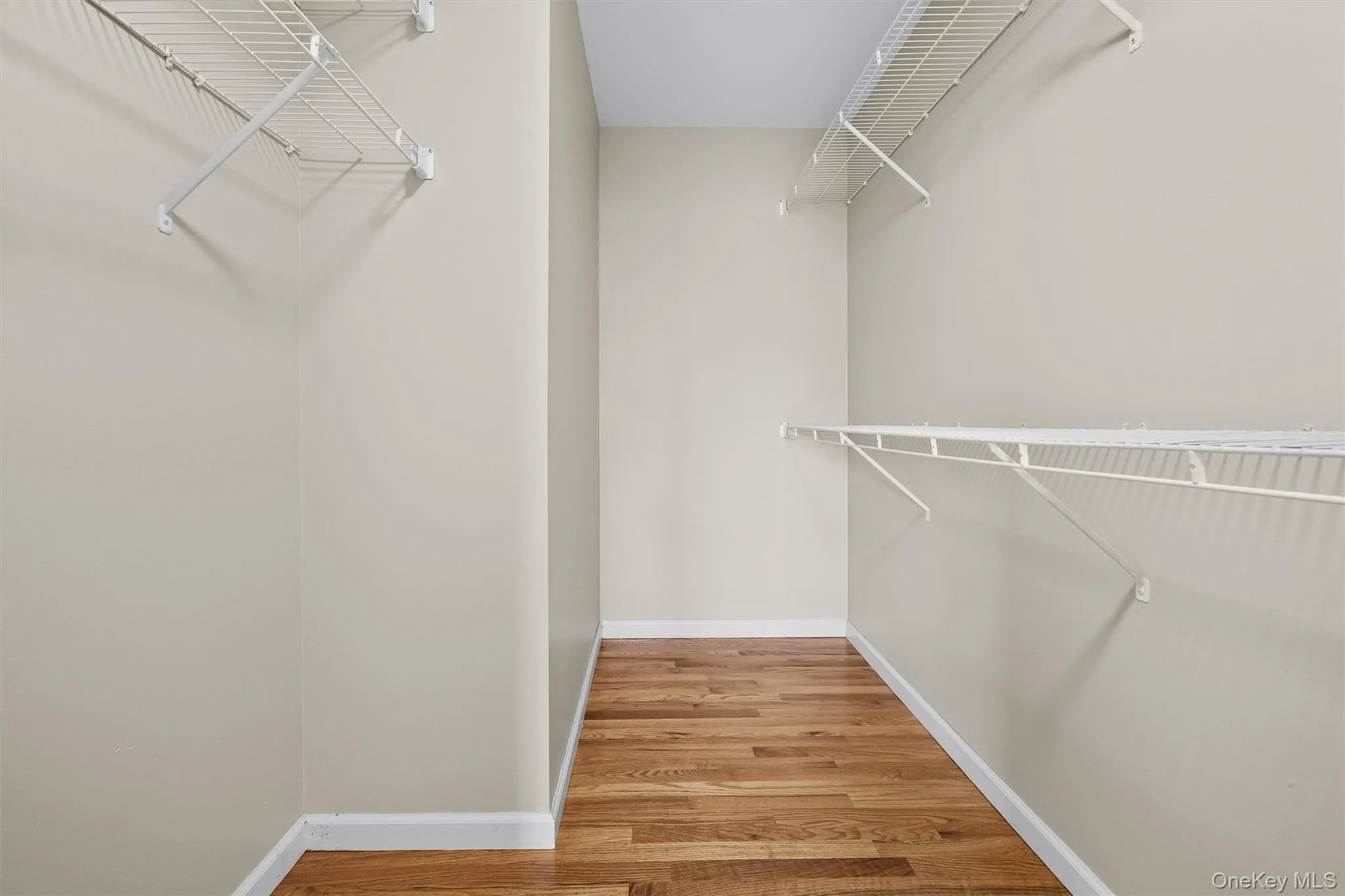 Spacious closet featuring wood finished floors Spacious closet featuring wood finished floors