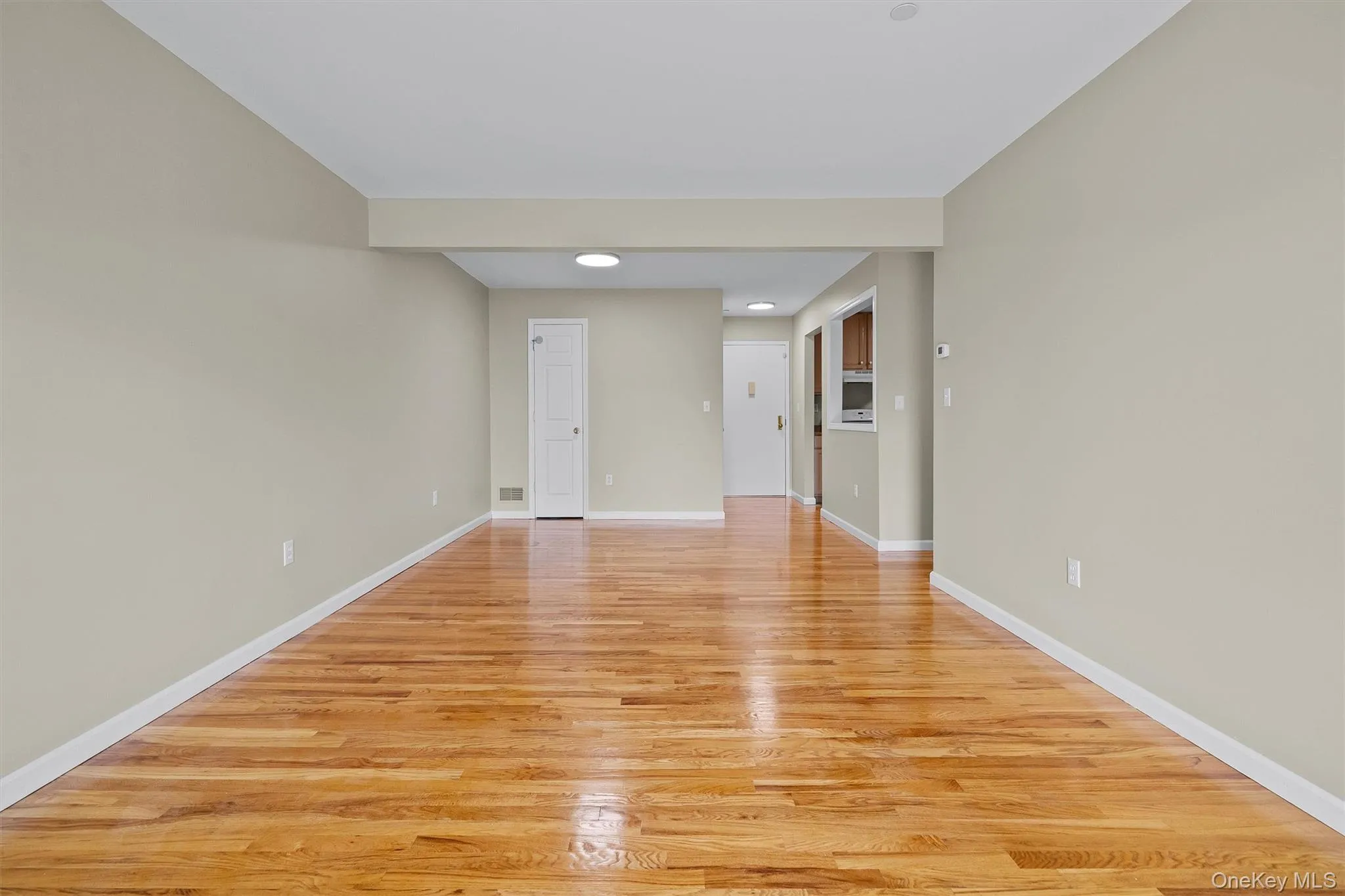 Unfurnished room with recessed lighting, light wood finished floors, and baseboards Unfurnished room with recessed lighting, light wood finished floors, and baseboards
