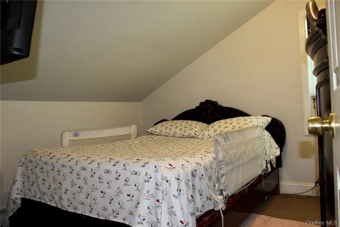 Bedroom featuring lofted ceiling Bedroom featuring lofted ceiling