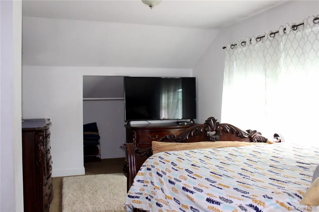 Bedroom with lofted ceiling Bedroom with lofted ceiling