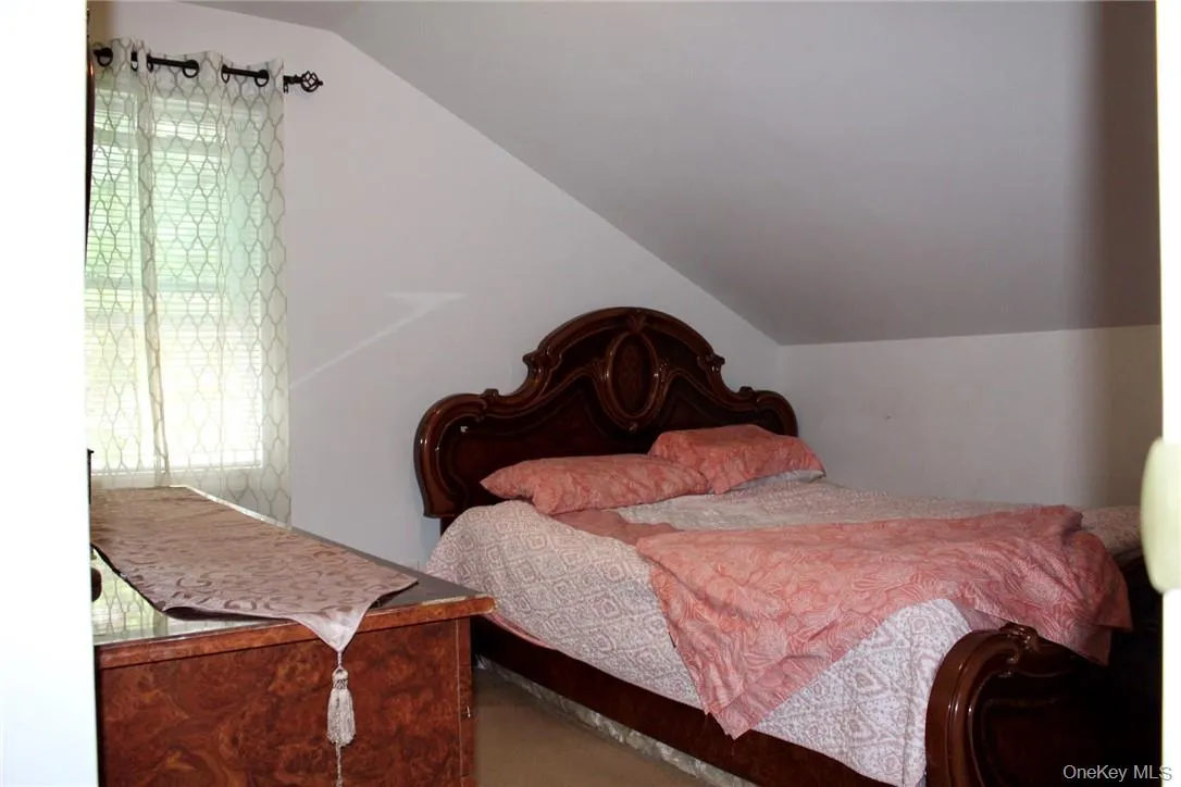Bedroom with lofted ceiling Bedroom with lofted ceiling