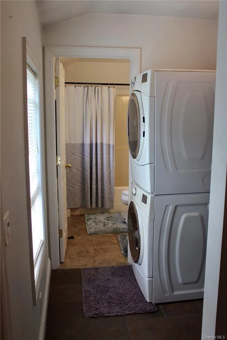 Laundry area with side by side washer and dryer. Stackable units replaced in 2021 Laundry area with side by side washer and dryer. Stackable units replaced in 2021
