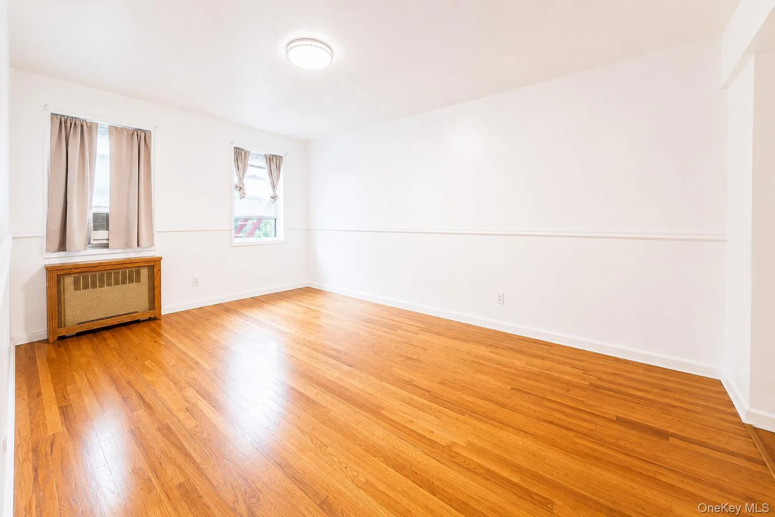 Bedroom features hardwood flooring and double windows. Bedroom features hardwood flooring and double windows.