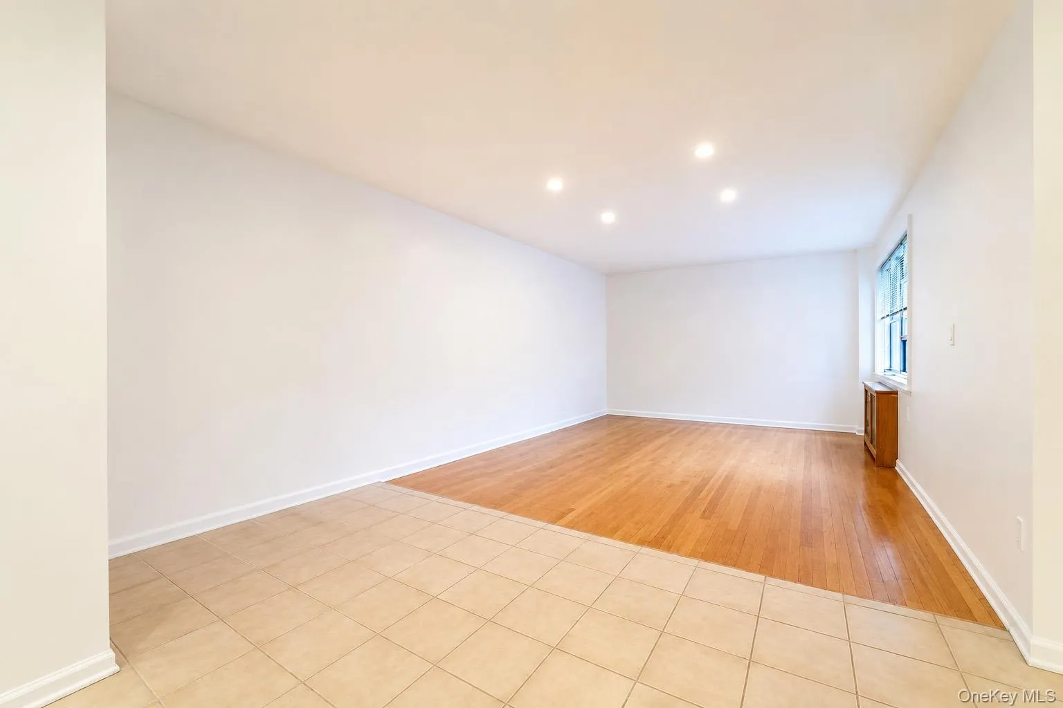 Living room with hardwood flooring and recessed lighting. Living room with hardwood flooring and recessed lighting.