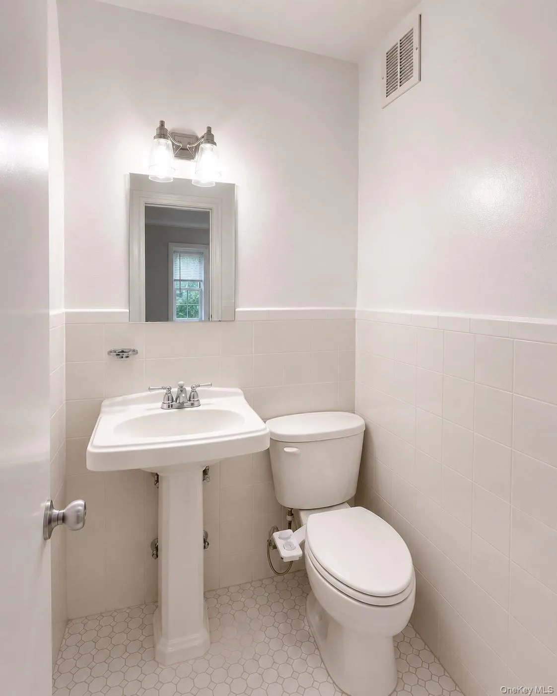 A conveniently placed powder room is located just off the hallway adjacent to the kitchen. A conveniently placed powder room is located just off the hallway adjacent to the kitchen.