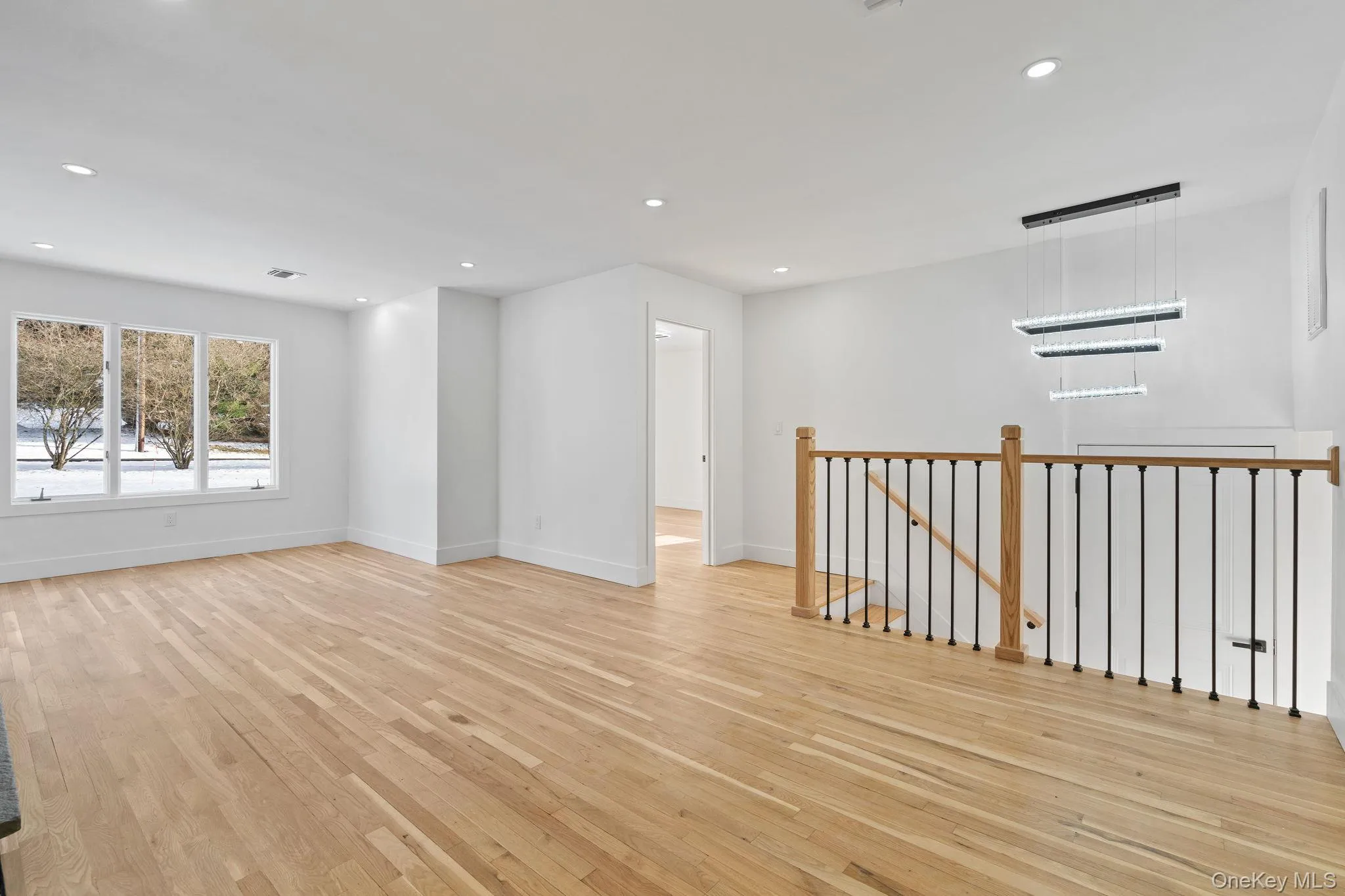 Empty room with light wood-style flooring and recessed lighting Empty room with light wood-style flooring and recessed lighting