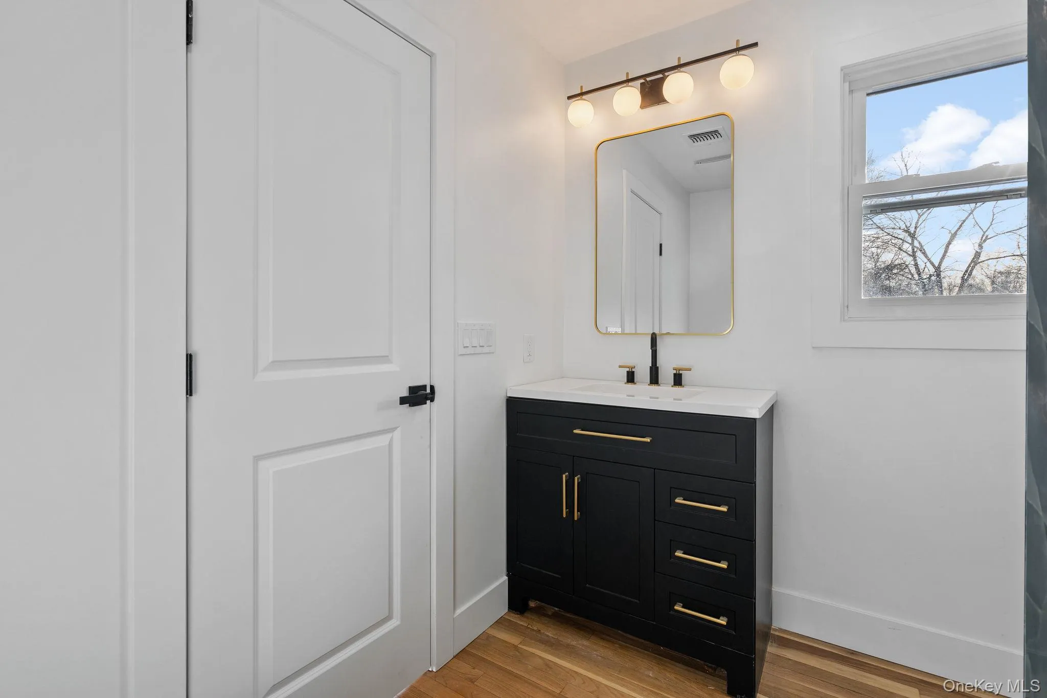 Bathroom featuring vanity and light wood-style floors Bathroom featuring vanity and light wood-style floors