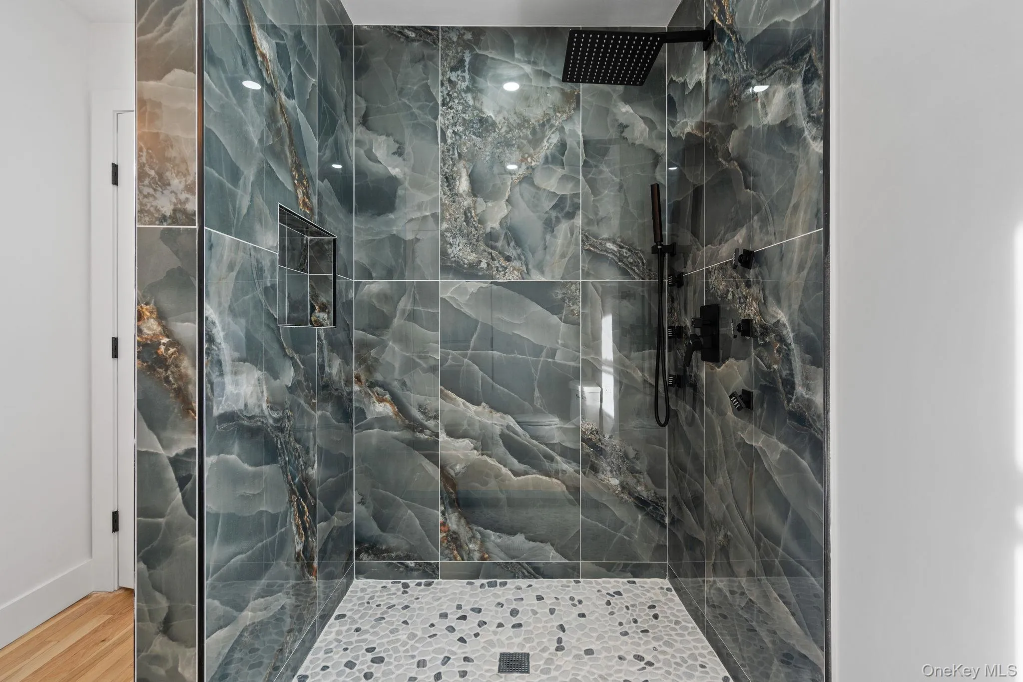 Bathroom featuring a marble finish shower Bathroom featuring a marble finish shower