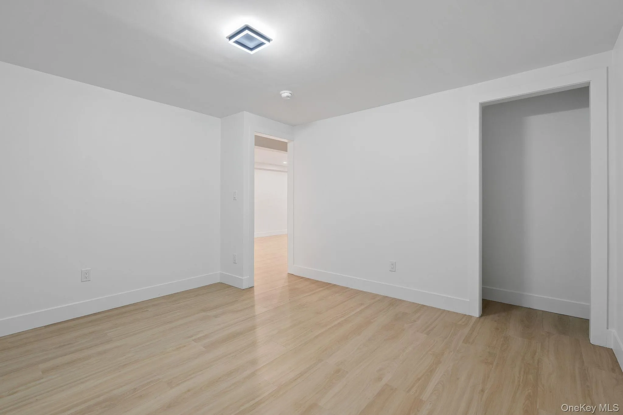 Unfurnished room featuring light wood-style floors and baseboards Unfurnished room featuring light wood-style floors and baseboards