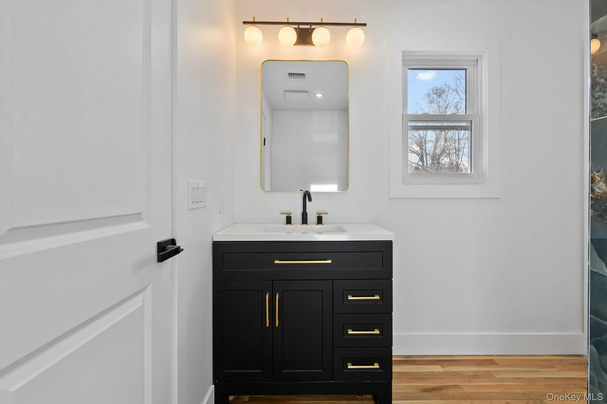 Bathroom featuring vanity and light wood-style floors Bathroom featuring vanity and light wood-style floors