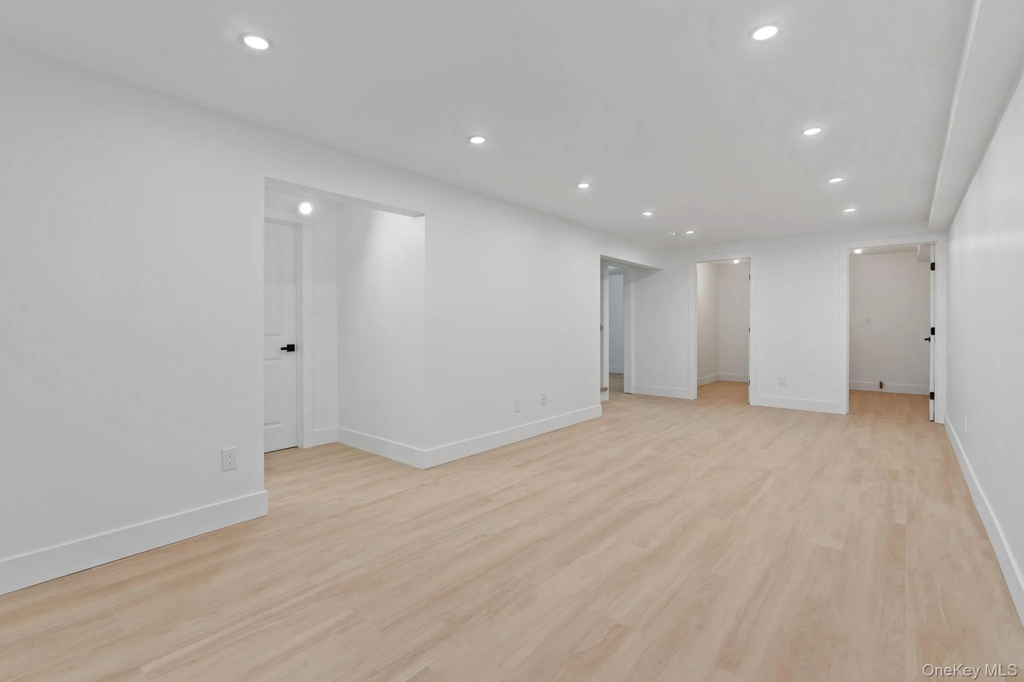 Unfurnished room featuring recessed lighting and light wood finished floors Unfurnished room featuring recessed lighting and light wood finished floors