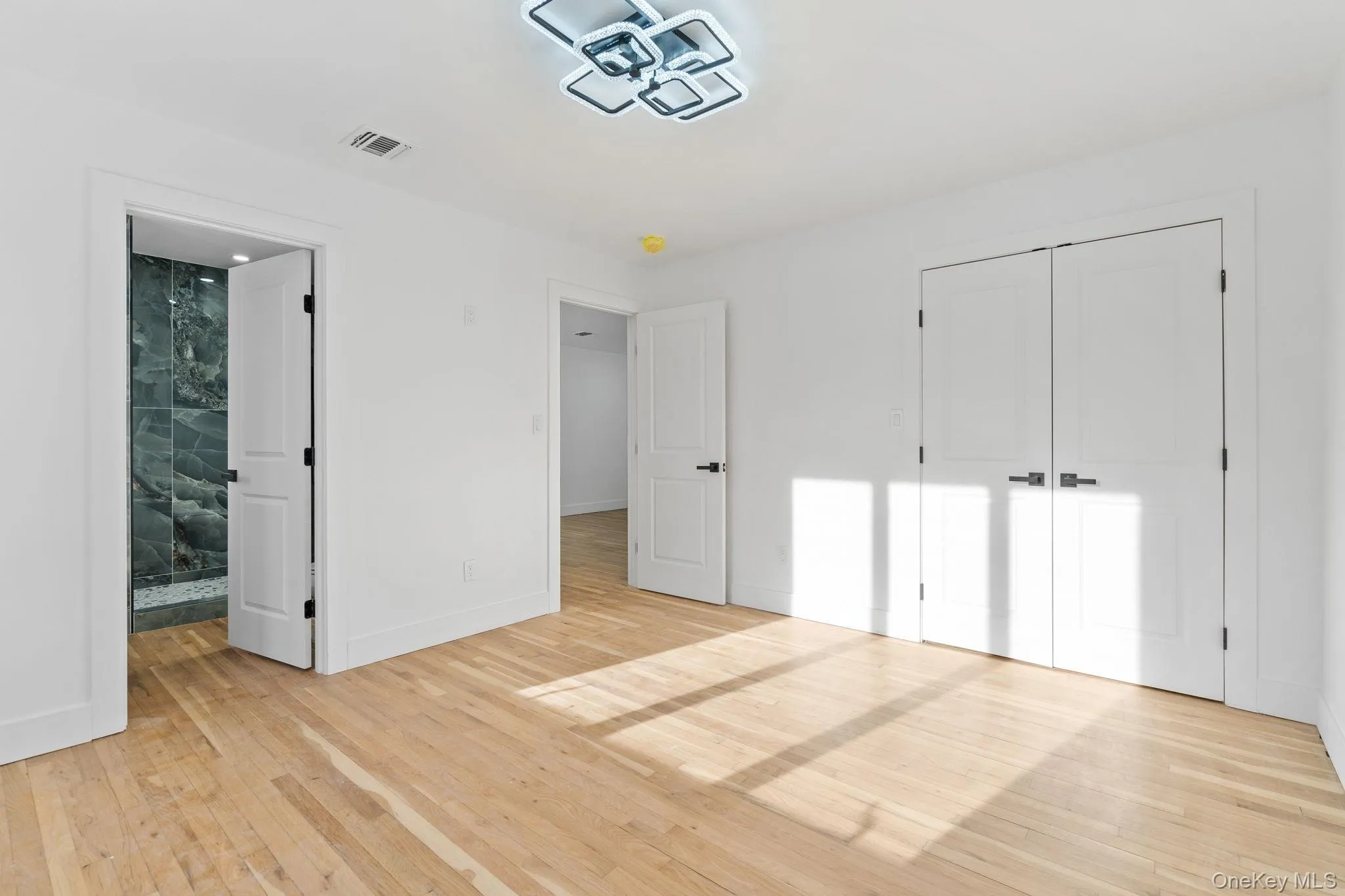 Unfurnished bedroom featuring light wood-style floors and a closet Unfurnished bedroom featuring light wood-style floors and a closet