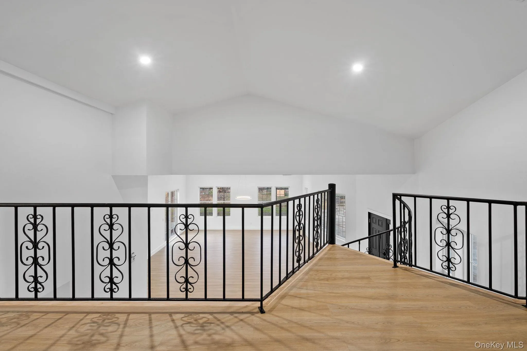 Corridor with lofted ceiling and an upstairs landing Corridor with lofted ceiling and an upstairs landing