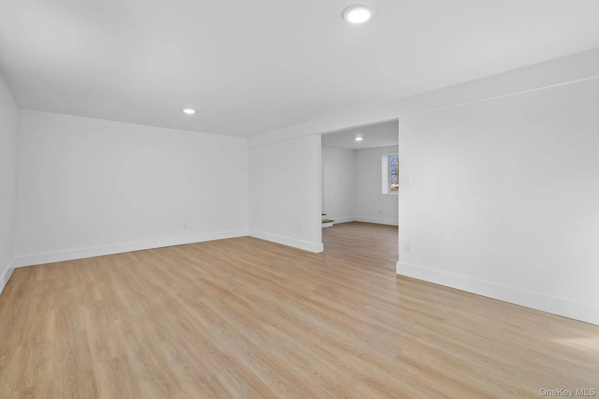 Unfurnished room with light wood-style flooring and recessed lighting Unfurnished room with light wood-style flooring and recessed lighting