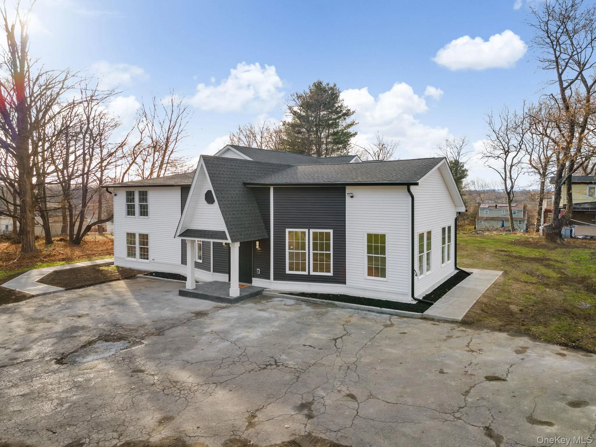 Rear view of house featuring a shingled roof and a patio Rear view of house featuring a shingled roof and a patio