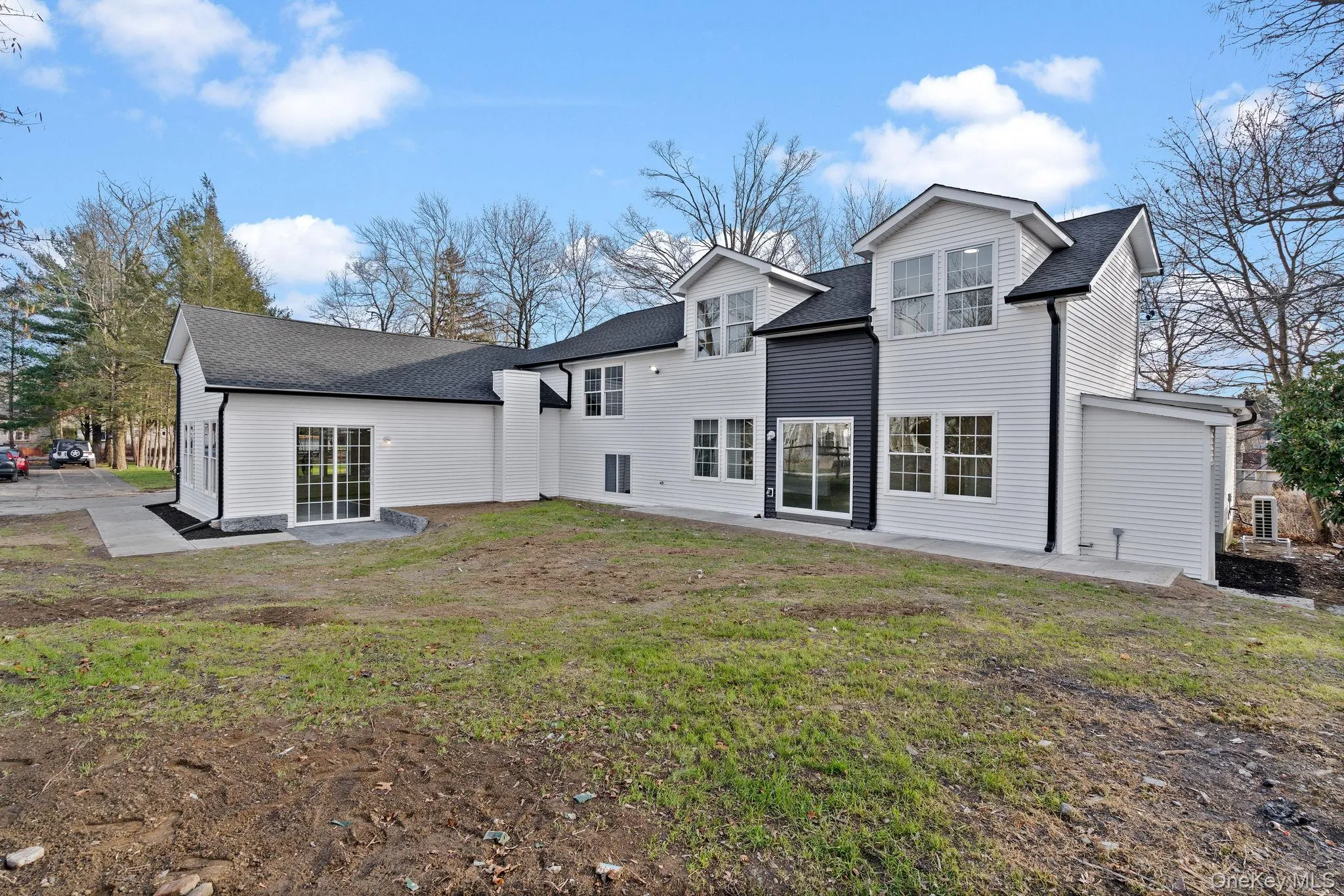 Rear view of property featuring roof with shingles, a yard, and a patio Rear view of property featuring roof with shingles, a yard, and a patio