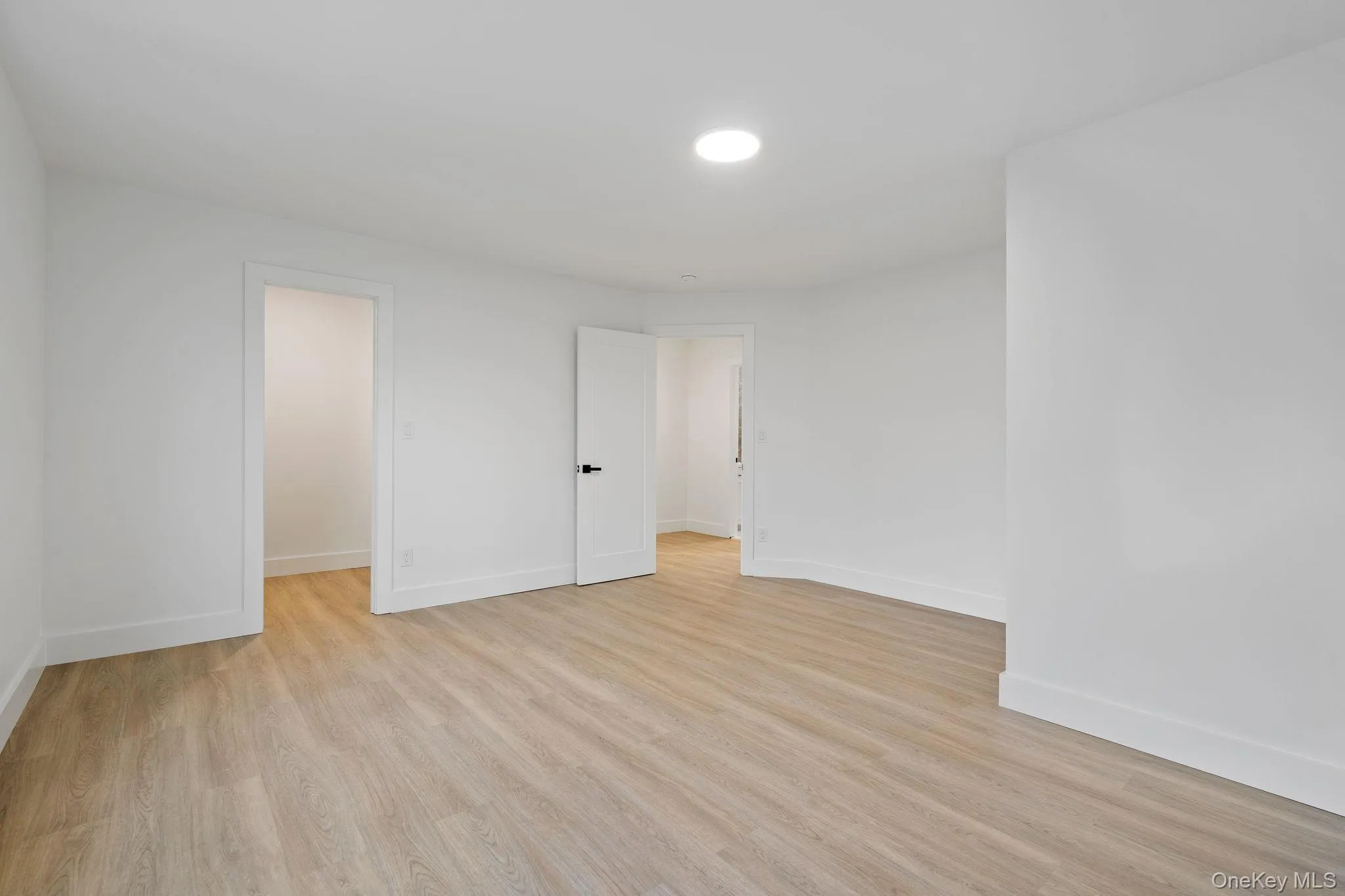 Empty room featuring light wood finished floors and baseboards Empty room featuring light wood finished floors and baseboards