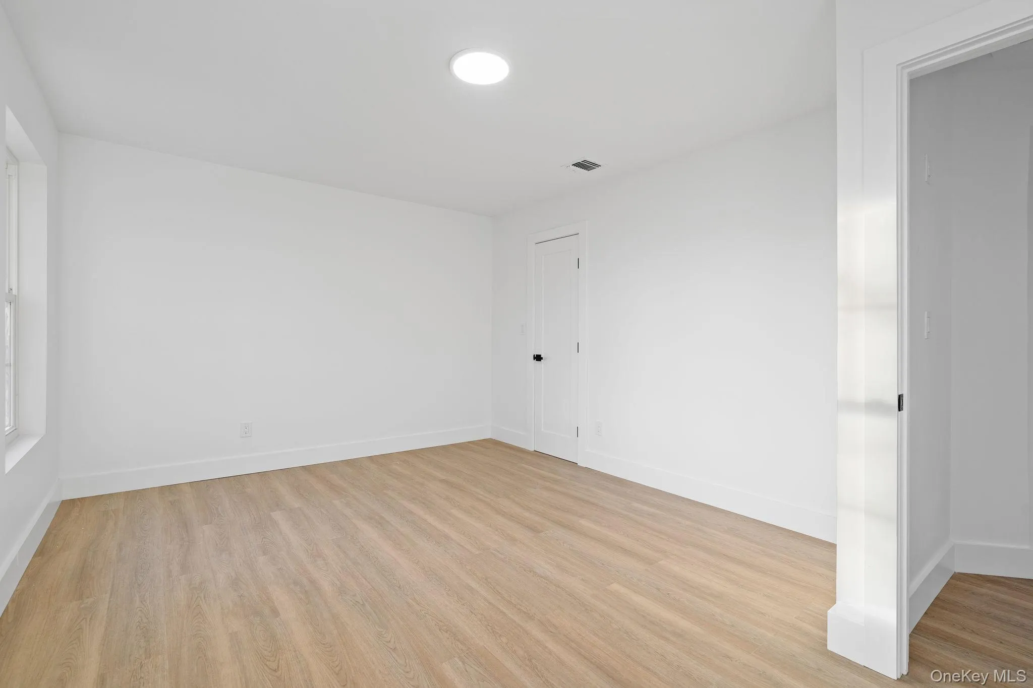 Unfurnished room with light wood finished floors Unfurnished room with light wood finished floors
