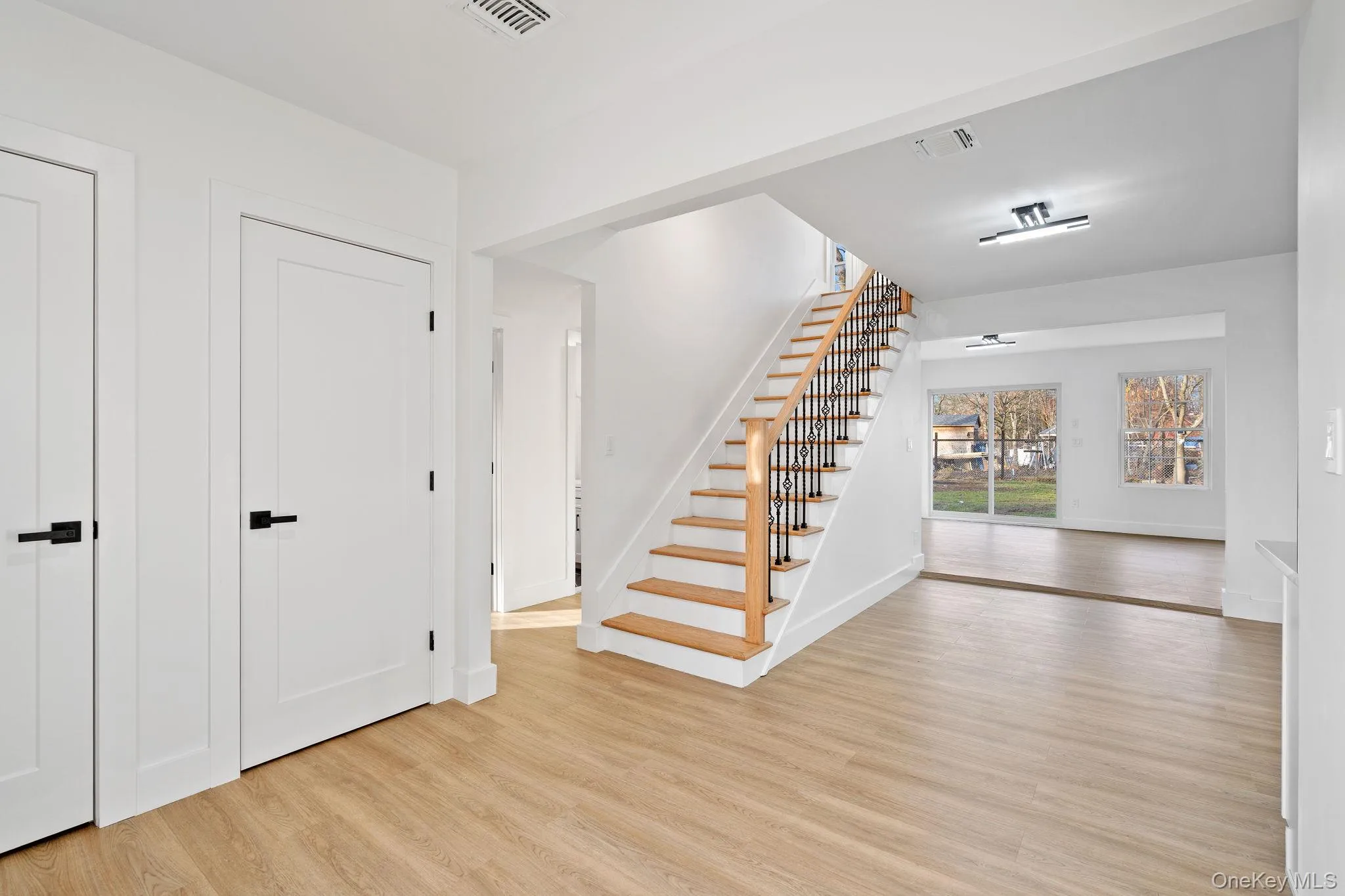 Entrance foyer with stairway and light wood-type flooring Entrance foyer with stairway and light wood-type flooring