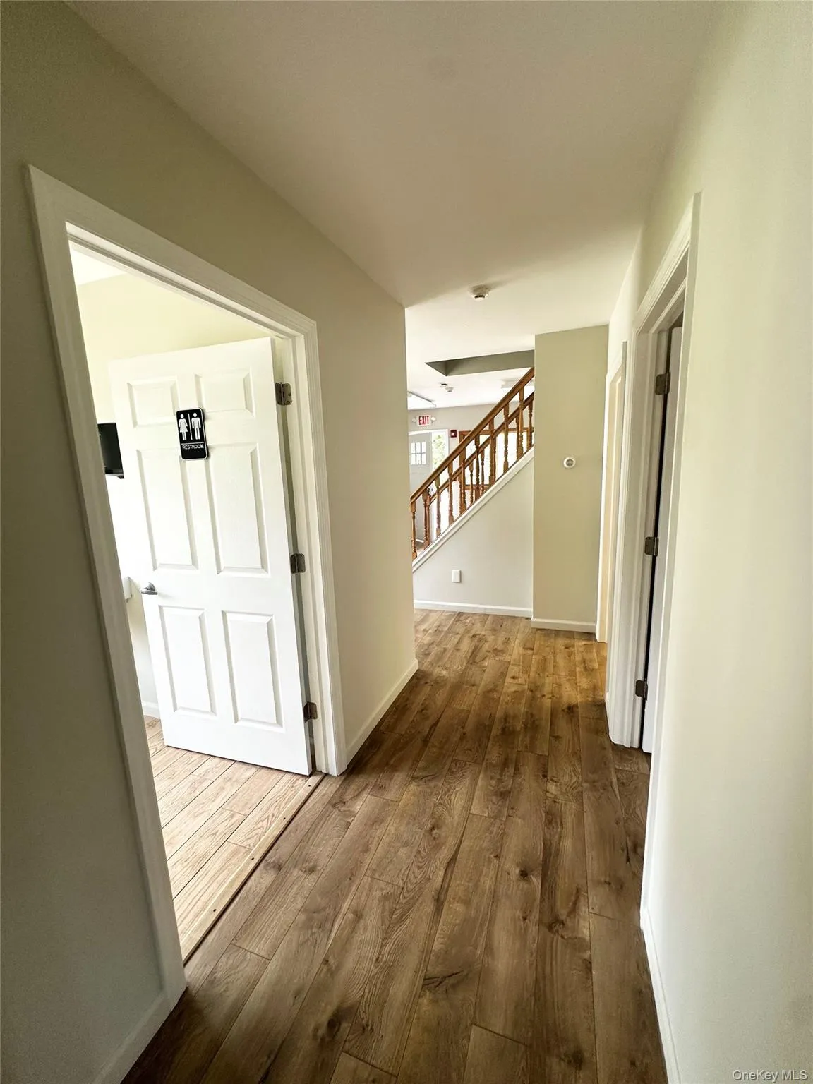 Corridor featuring dark wood-style floors and stairs Corridor featuring dark wood-style floors and stairs