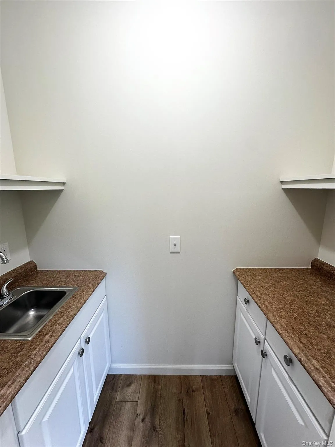 Washroom with dark wood finished floors and baseboards Washroom with dark wood finished floors and baseboards
