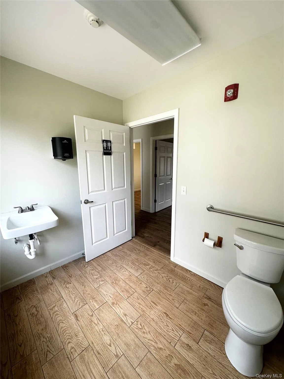 Bathroom with light wood finished floors and toilet Bathroom with light wood finished floors and toilet