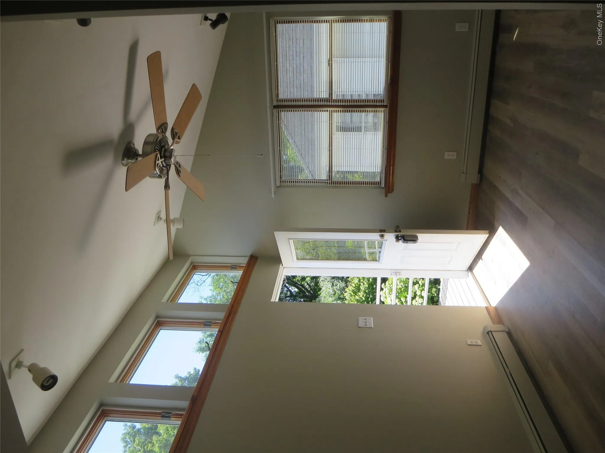 Modern living room with ceiling fan and central air. Modern living room with ceiling fan and central air.