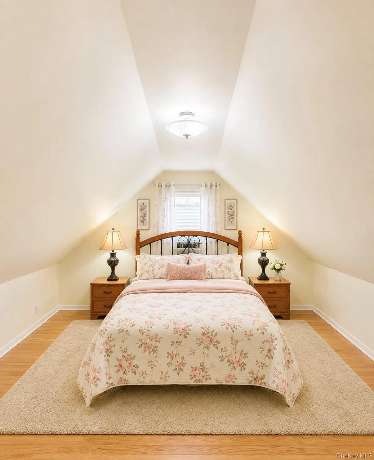 Attic bedroom featuring pitched ceilings, wood-finish flooring, and a window with sheer curtains Attic bedroom featuring pitched ceilings, wood-finish flooring, and a window with sheer curtains