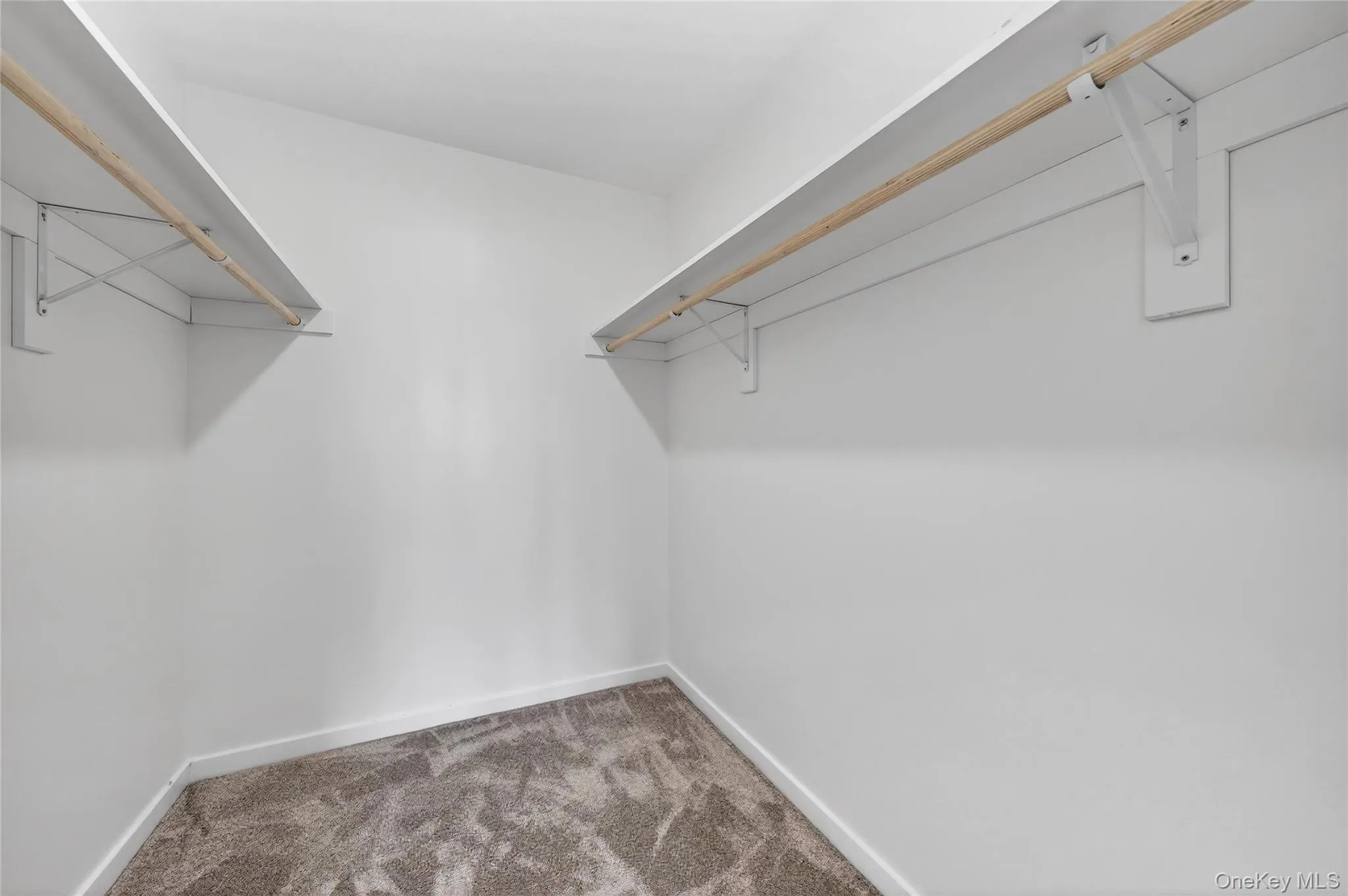 Walk-in closet in the primary bedroom. Walk-in closet in the primary bedroom.