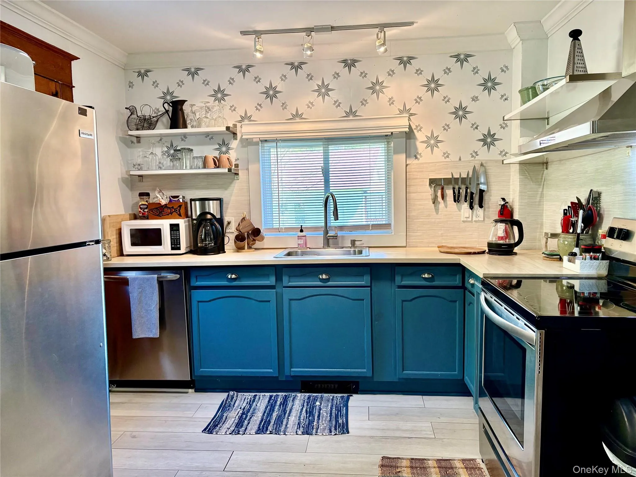 Lovely updated kitchen w stainless steel appliances w a back door leading to the entertaining deck Lovely updated kitchen w stainless steel appliances w a back door leading to the entertaining deck