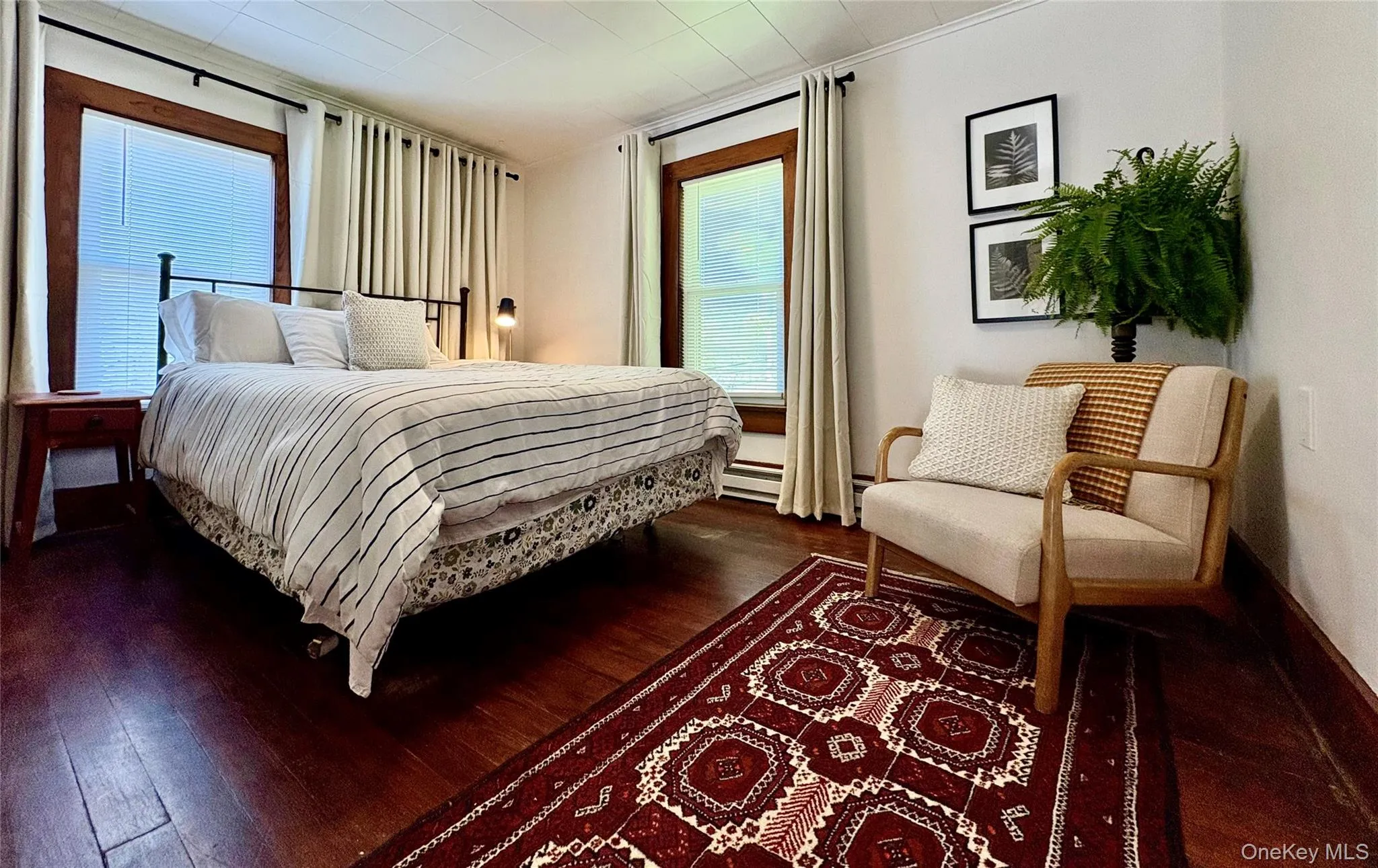 Hardwood flooring enhances this room featuring multiple windows with wood trim Hardwood flooring enhances this room featuring multiple windows with wood trim