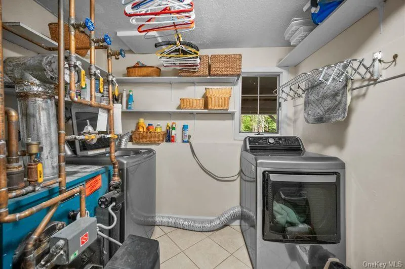 Laundry room / utility room located in lower level of house Laundry room / utility room located in lower level of house