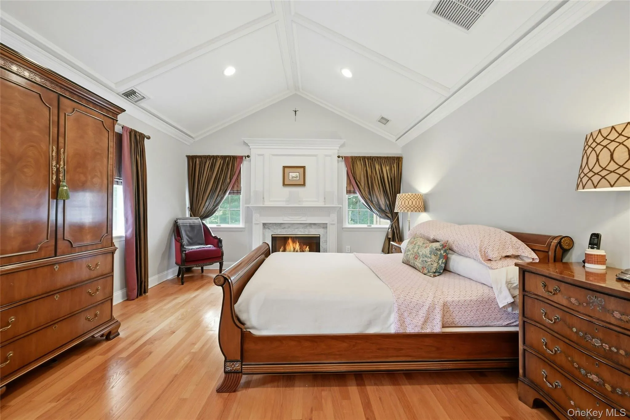 The Exquisite Primary Bedroom Suite Is An Elegant, Private Oasis Offering Soaring Custom Paneled Ceilings, Fireplace With A Stunning Custom Mantel, Marble Surround & Base, Box Paneled Trim & Beautiful Moldings/Details Flanked By Two Large Windows (There Are Five Large Windows In The Bedroom Illuminating The Room With Natural Light), Hardwood Floors, Ample Room For A Very Large Bedroom Set/Furniture, An Expansive Custom Built Walk In Closet With Built In Shelving/Storage, Second Double Sized Closet, And A Magnificent Primary Bathroom. The Exquisite Primary Bedroom Suite Is An Elegant, Private Oasis Offering Soaring Custom Paneled Ceilings, Fireplace With A Stunning Custom Mantel, Marble Surround & Base, Box Paneled Trim & Beautiful Moldings/Details Flanked By Two Large Windows (There Are Five Large Windows In The Bedroom Illuminating The Room With Natural Light), Hardwood Floors, Ample Room For A Very Large Bedroom Set/Furniture, An Expansive Custom Built Walk In Closet With Built In Shelving/Storage, Second Double Sized Closet, And A Magnificent Primary Bathroom.