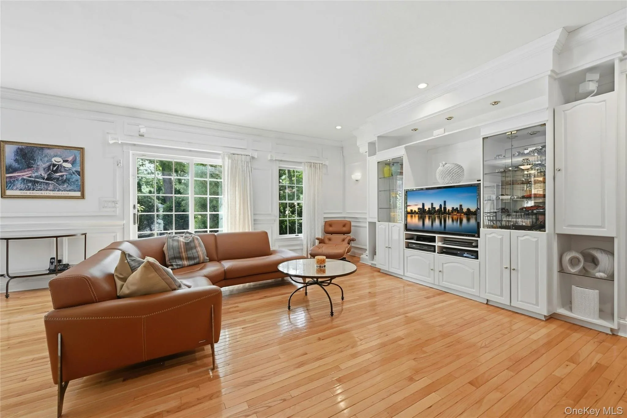 The Expansive 20'3" x 18'8" Den/Family Room Was Expanded Two Feet Out The Back Of The Home & An Additional Two Feet Towards The Garage Offering A Perfect, Vast Space For Entertaining With 9' Ceilings, Stunning Box Paneled/Wainscoted Walls, Beautiful Hardwood Floors, Andersen Sliding Doors & Oversized Windows Overlooking The Backyard & In Ground Pool, A Striking Custom Built Wall Unit/Entertainment Center With Magnificent Crown Moldings, Columns, Glass Doors & Shelving, Built In Television (Which Stays With The Home) & Built In Lighting, Ample Room For A Very Large Furniture/Seating Area, And Access To The Half Bathroom/Powder Room & Two Car Garage. The Expansive 20'3" x 18'8" Den/Family Room Was Expanded Two Feet Out The Back Of The Home & An Additional Two Feet Towards The Garage Offering A Perfect, Vast Space For Entertaining With 9' Ceilings, Stunning Box Paneled/Wainscoted Walls, Beautiful Hardwood Floors, Andersen Sliding Doors & Oversized Windows Overlooking The Backyard & In Ground Pool, A Striking Custom Built Wall Unit/Entertainment Center With Magnificent Crown Moldings, Columns, Glass Doors & Shelving, Built In Television (Which Stays With The Home) & Built In Lighting, Ample Room For A Very Large Furniture/Seating Area, And Access To The Half Bathroom/Powder Room & Two Car Garage.