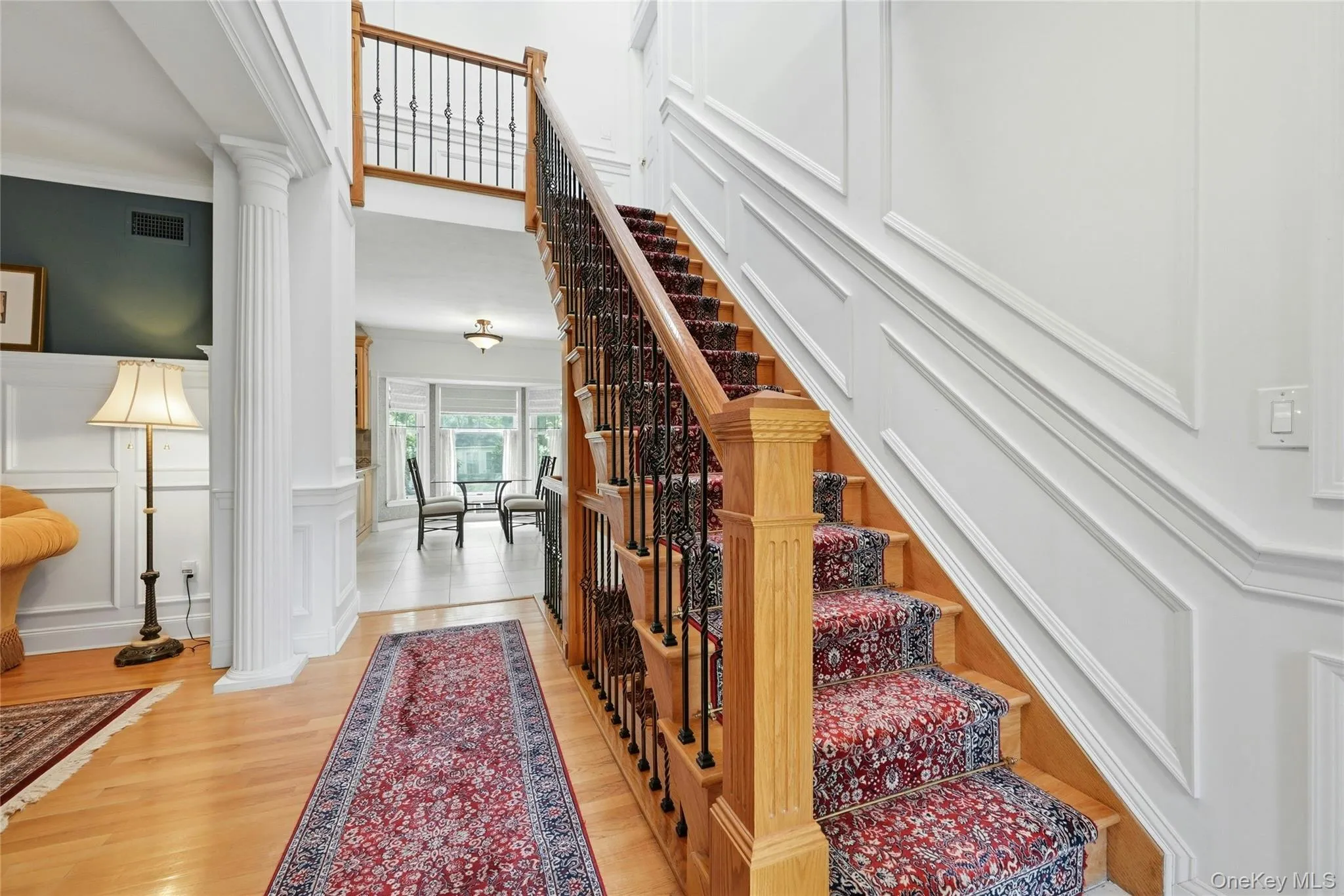 Welcomed By An Exquisite Formal Entrance Foyer Offering A Stunning Two Story Stairway To To The Second Level With Custom Oak & Wrought Iron Bannisters, Railings, Spindles & Stairs, Magnificent Fully Floor To Ceiling Box Paneled/Wainscoted Walls, Beautiful Hardwood Floors, A Two Column Entrance Into The Formal Living Room & Then Opens Into The Kitchen, Dinette And Den/Family Room. Welcomed By An Exquisite Formal Entrance Foyer Offering A Stunning Two Story Stairway To To The Second Level With Custom Oak & Wrought Iron Bannisters, Railings, Spindles & Stairs, Magnificent Fully Floor To Ceiling Box Paneled/Wainscoted Walls, Beautiful Hardwood Floors, A Two Column Entrance Into The Formal Living Room & Then Opens Into The Kitchen, Dinette And Den/Family Room.