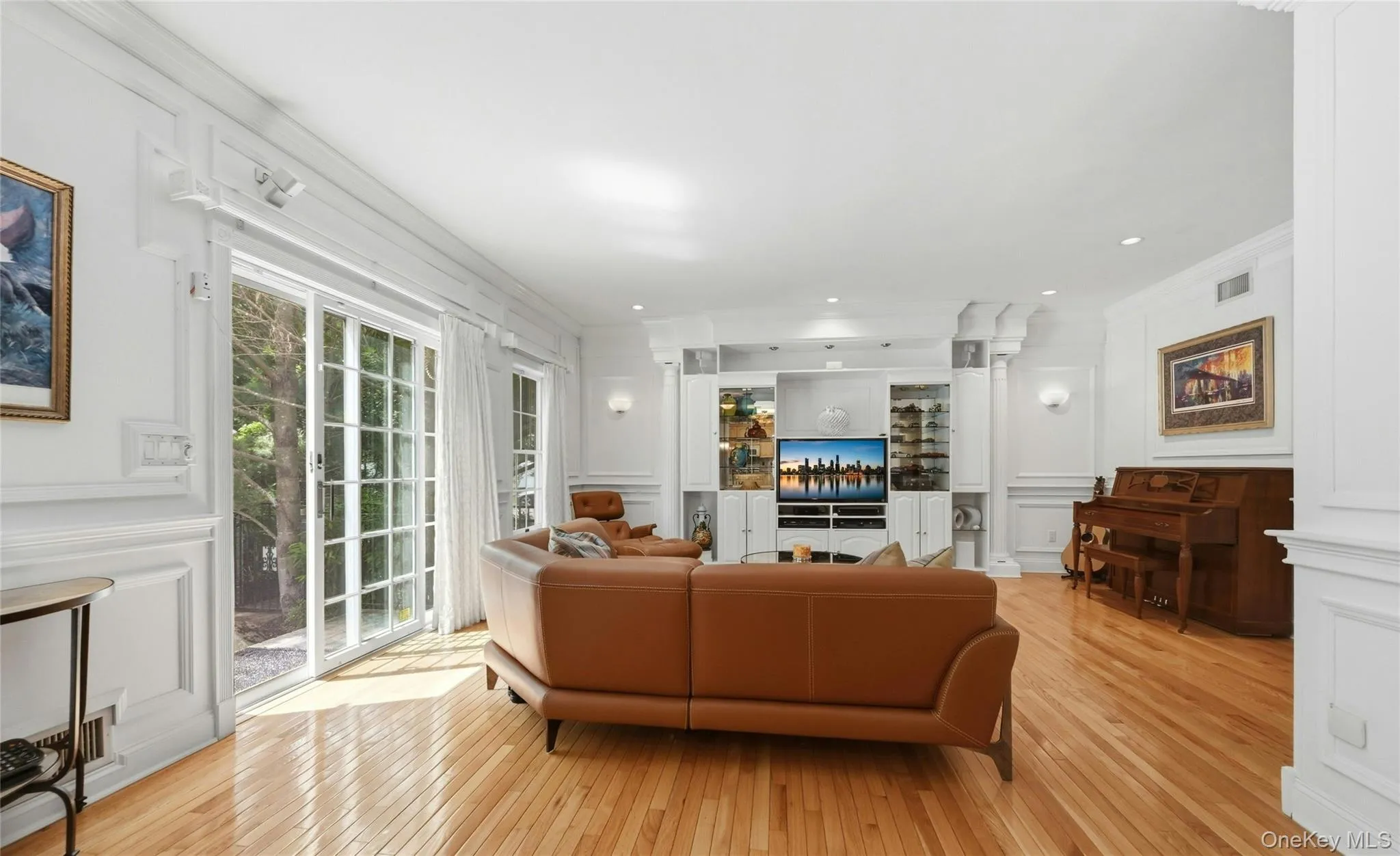 The Expansive 20'3" x 18'8" Den/Family Room Was Expanded Two Feet Out The Back Of The Home & An Additional Two Feet Towards The Garage Offering A Perfect, Vast Space For Entertaining With 9' Ceilings, Stunning Box Paneled/Wainscoted Walls, Beautiful Hardwood Floors, Andersen Sliding Doors & Oversized Windows Overlooking The Backyard & In Ground Pool, A Striking Custom Built Wall Unit/Entertainment Center With Magnificent Crown Moldings, Columns, Glass Doors & Shelving, Built In Television (Which Stays With The Home) & Built In Lighting, Ample Room For A Very Large Furniture/Seating Area, And Access To The Half Bathroom/Powder Room & Two Car Garage. The Expansive 20'3" x 18'8" Den/Family Room Was Expanded Two Feet Out The Back Of The Home & An Additional Two Feet Towards The Garage Offering A Perfect, Vast Space For Entertaining With 9' Ceilings, Stunning Box Paneled/Wainscoted Walls, Beautiful Hardwood Floors, Andersen Sliding Doors & Oversized Windows Overlooking The Backyard & In Ground Pool, A Striking Custom Built Wall Unit/Entertainment Center With Magnificent Crown Moldings, Columns, Glass Doors & Shelving, Built In Television (Which Stays With The Home) & Built In Lighting, Ample Room For A Very Large Furniture/Seating Area, And Access To The Half Bathroom/Powder Room & Two Car Garage.
