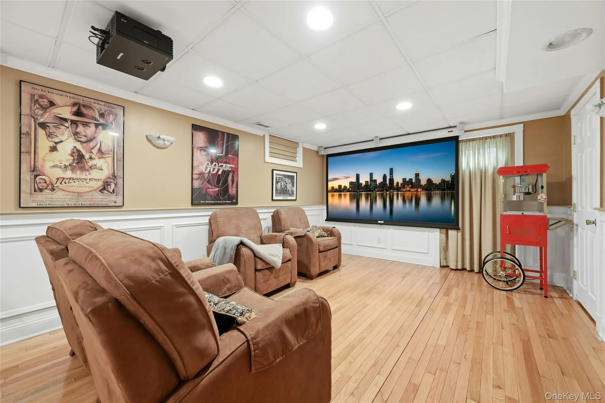 The Spectacular Expansive Lower Level Media Room Is The Epitome Of Entertaining & Recreation Space..Offering A Movie Projector, Screen, 5.1 Bose Surround System, Entertainment Styled Box Paneled/Wainscoted Walls With Custom Moldings, Built In Bench/Seating Spaces, An Oversized Stunning Custom Wet Bar With Maple Cabinetry, Glass Doors, Corian Countertops With Built In Barstool Area, Accent Tiled Backsplash, Refrigerator & Built In Microwave Oven, Hardwood Floors Throughout, Recessed Lighting, All Custom Details, And Dual Columns To A Separate Exercise Room. The Spectacular Expansive Lower Level Media Room Is The Epitome Of Entertaining & Recreation Space..Offering A Movie Projector, Screen, 5.1 Bose Surround System, Entertainment Styled Box Paneled/Wainscoted Walls With Custom Moldings, Built In Bench/Seating Spaces, An Oversized Stunning Custom Wet Bar With Maple Cabinetry, Glass Doors, Corian Countertops With Built In Barstool Area, Accent Tiled Backsplash, Refrigerator & Built In Microwave Oven, Hardwood Floors Throughout, Recessed Lighting, All Custom Details, And Dual Columns To A Separate Exercise Room.