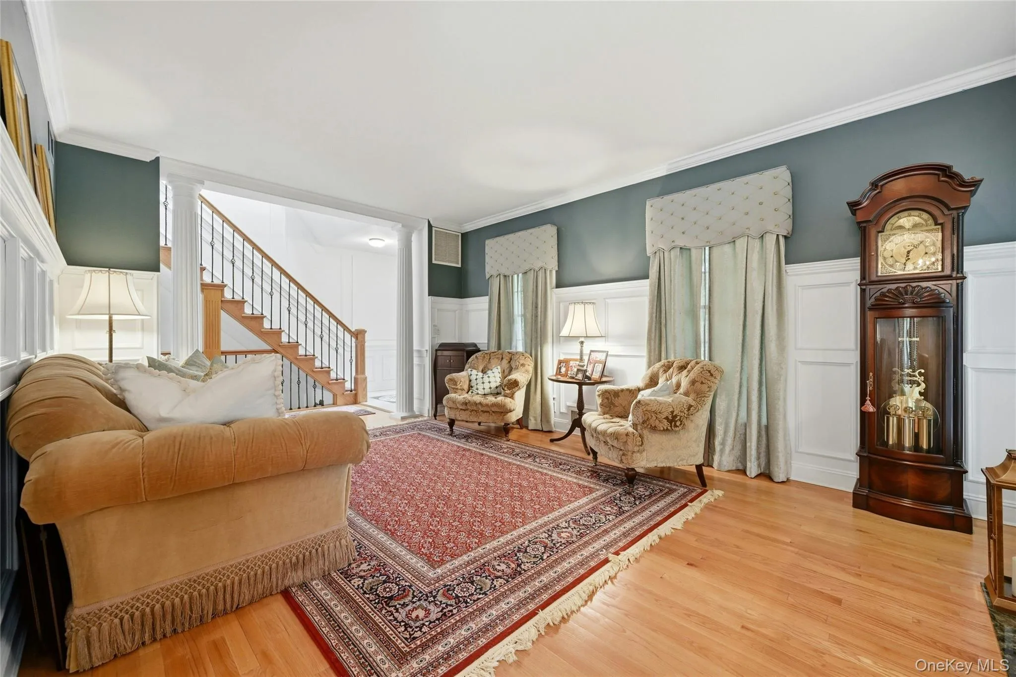 The Elegant, Stunning Formal Living Room Offers A Two Columned Entrance, Spectacular 6' Box Paneled/Wainscoted Walls, Magnificent Focal Point Wood Burning Fireplace With A Custom Floor To Ceiling Wood Mantel, Marble Surround & Base Flanked By Exquisite Stained Glass Windows, 9' Ceilings With Oversized Andersen Windows, Custom Moldings, Hardwood Floors & A Beautiful Custom Archway (Also With Beautiful Moldings/Trims) Into The Formal Dining Room. The Elegant, Stunning Formal Living Room Offers A Two Columned Entrance, Spectacular 6' Box Paneled/Wainscoted Walls, Magnificent Focal Point Wood Burning Fireplace With A Custom Floor To Ceiling Wood Mantel, Marble Surround & Base Flanked By Exquisite Stained Glass Windows, 9' Ceilings With Oversized Andersen Windows, Custom Moldings, Hardwood Floors & A Beautiful Custom Archway (Also With Beautiful Moldings/Trims) Into The Formal Dining Room.