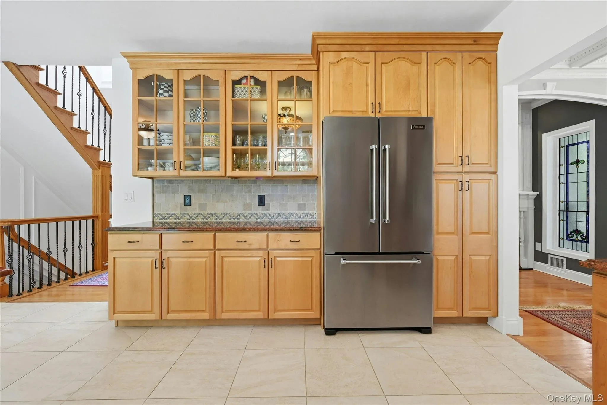 Another View Of The Spectacular Three Year Old Chef's Kitchen Offers Walls Of Extra Height Custom Maple Cabinetry With Beautiful Moldings, Detailwork & Trims, Glass Doors, Premium Granite Countertops With Expansive Counter/Serving Areas, Tiled Backsplash With Accent Border, Stunning Circle Topped Window Over The Sink, A Suite Of Viking Stainless Steel Appliances (Including A Gas Range), Porcelain Tiled Floors & A Large Dinette Area Which Opens Into The Family Room/Den. Another View Of The Spectacular Three Year Old Chef's Kitchen Offers Walls Of Extra Height Custom Maple Cabinetry With Beautiful Moldings, Detailwork & Trims, Glass Doors, Premium Granite Countertops With Expansive Counter/Serving Areas, Tiled Backsplash With Accent Border, Stunning Circle Topped Window Over The Sink, A Suite Of Viking Stainless Steel Appliances (Including A Gas Range), Porcelain Tiled Floors & A Large Dinette Area Which Opens Into The Family Room/Den.