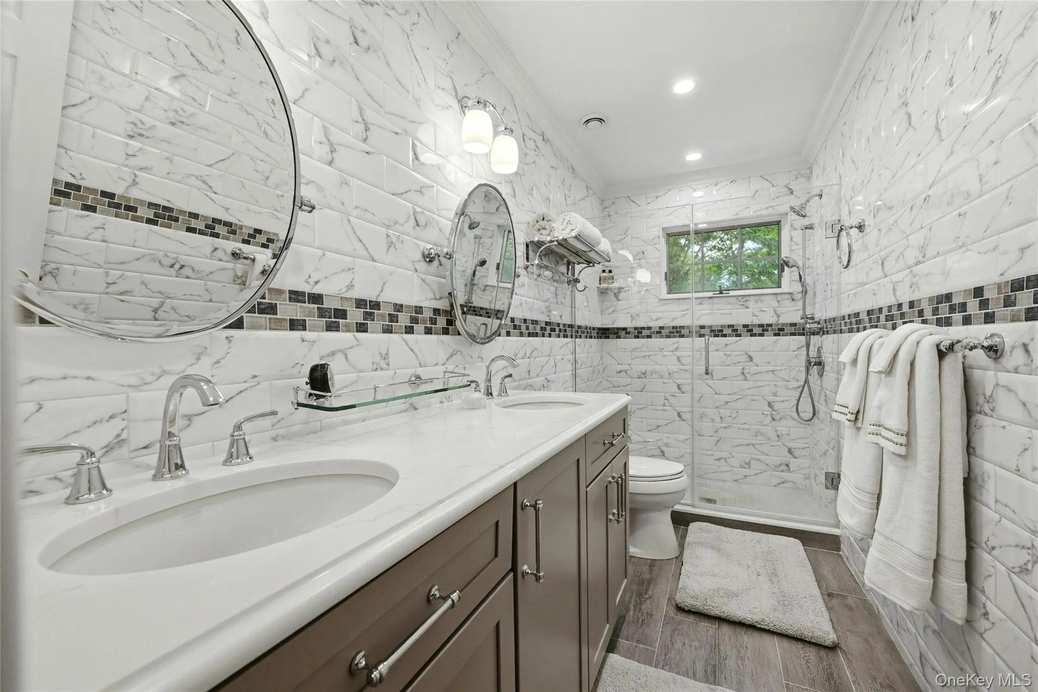 The Magnificent New $40,000 Guest Bathroom Is Completely Wrapped In Floor To Ceiling Stunning Subway Tiled Walls With Accent Borders/Trims, An Oversized Custom Shower With Frameless Glass Doors, Dual Sink Quartz Topped Vanity, Custom Moldings, Recessed Lighting, Porcelain Plank Tiled Floors & All High End Fixtures. The Magnificent New $40,000 Guest Bathroom Is Completely Wrapped In Floor To Ceiling Stunning Subway Tiled Walls With Accent Borders/Trims, An Oversized Custom Shower With Frameless Glass Doors, Dual Sink Quartz Topped Vanity, Custom Moldings, Recessed Lighting, Porcelain Plank Tiled Floors & All High End Fixtures.